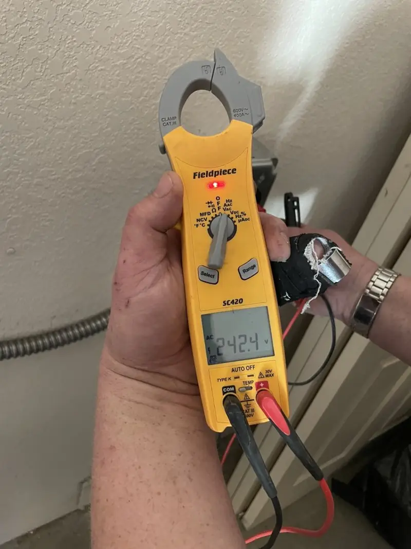 Voltage testing with clamp meter during Outlet Installation in Walton